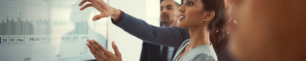 professionals looking at data on whiteboard