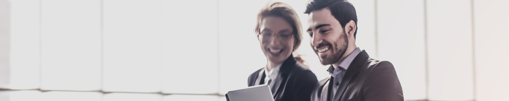 two professionals walking with computer