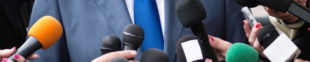 several microphones in front of man