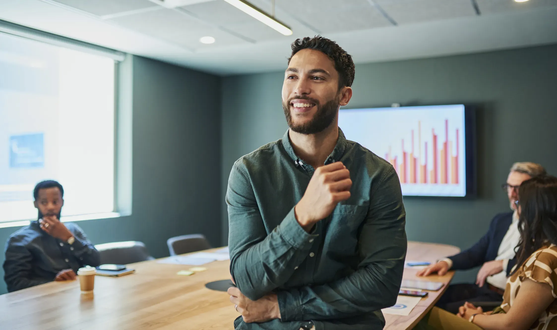 A man smiling in a conference room